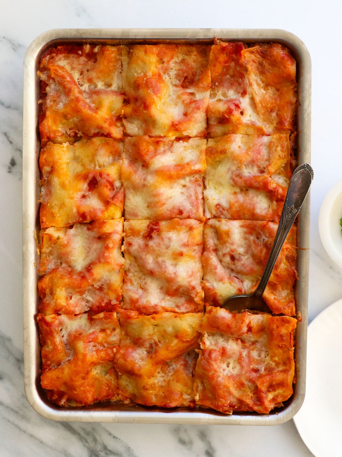 cottage cheese lasagna sliced into 12 squares for serving.
