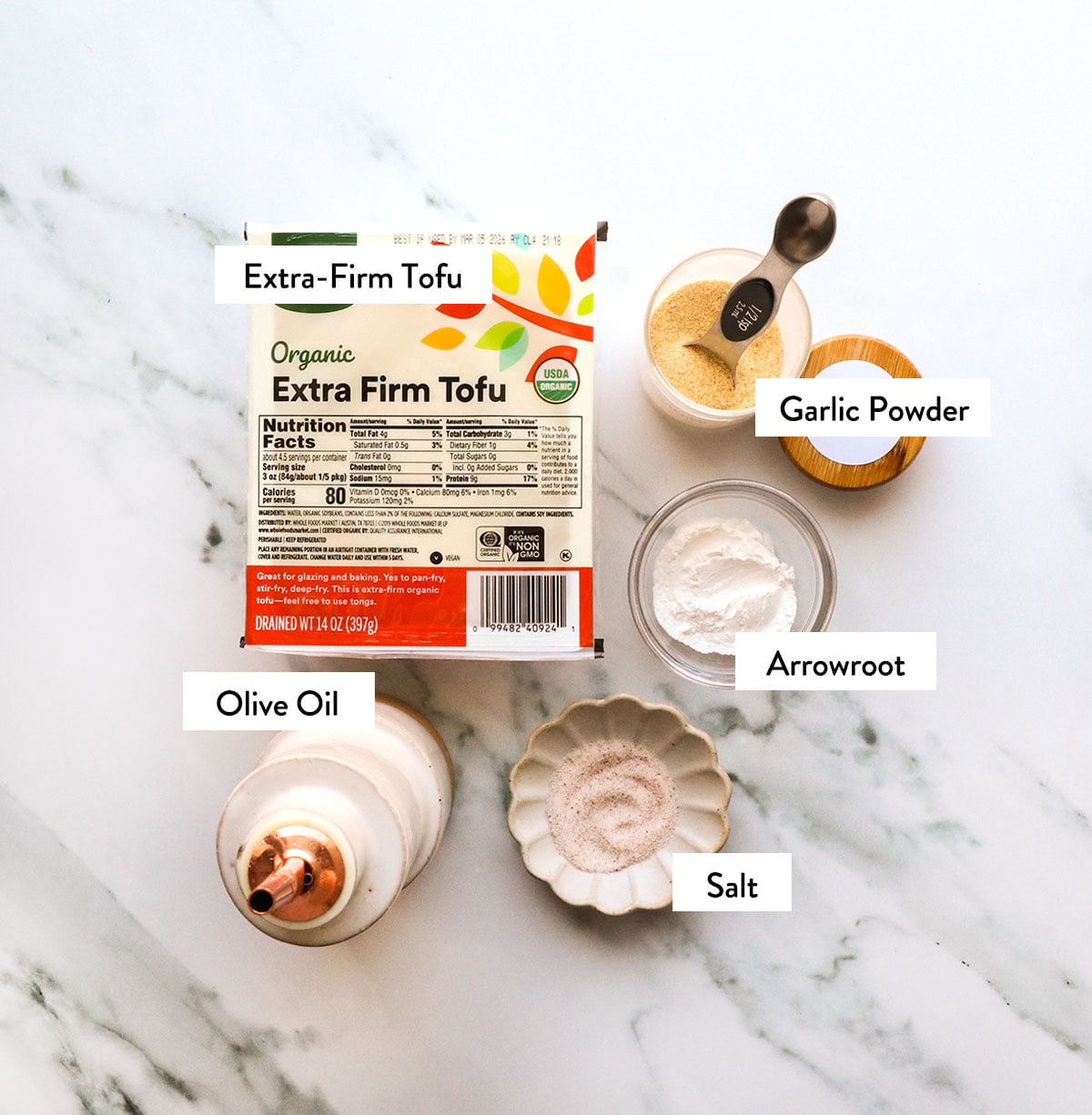 tofu, olive oil, and spices labeled in small bowls.