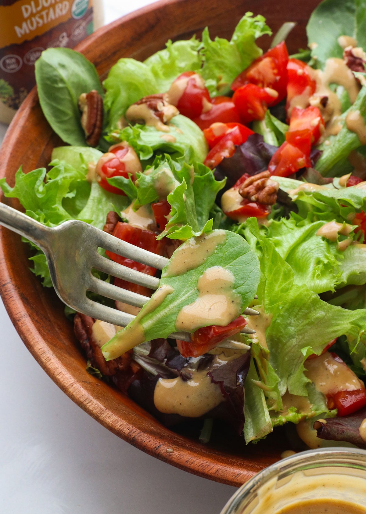 honey balsamic vinaigrette on a lettuce leaf with a fork.