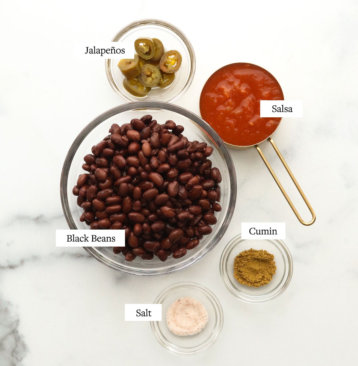 black bean dip labeled on white surface.
