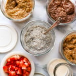 thickened chia pudding in glass jars with 3 flavors nearby.