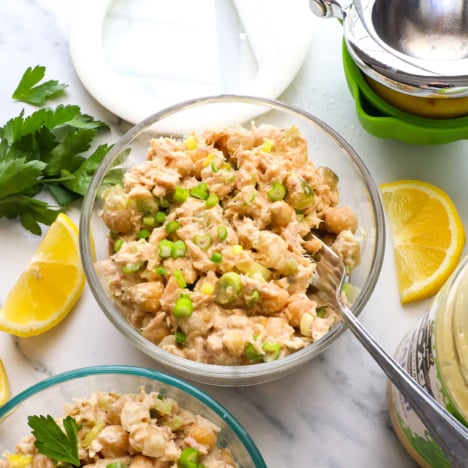 tuna and chickpea salad stored in a meal prep container and served with a fork.