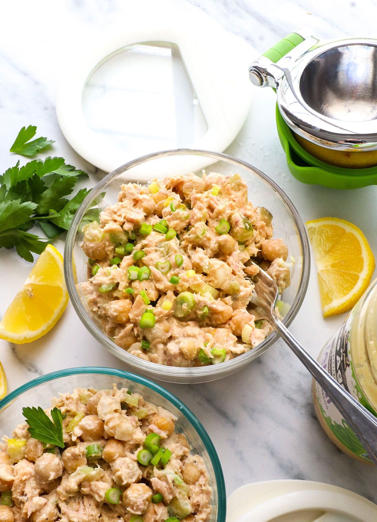 tuna and chickpea salad stored in a meal prep container and served with a fork.