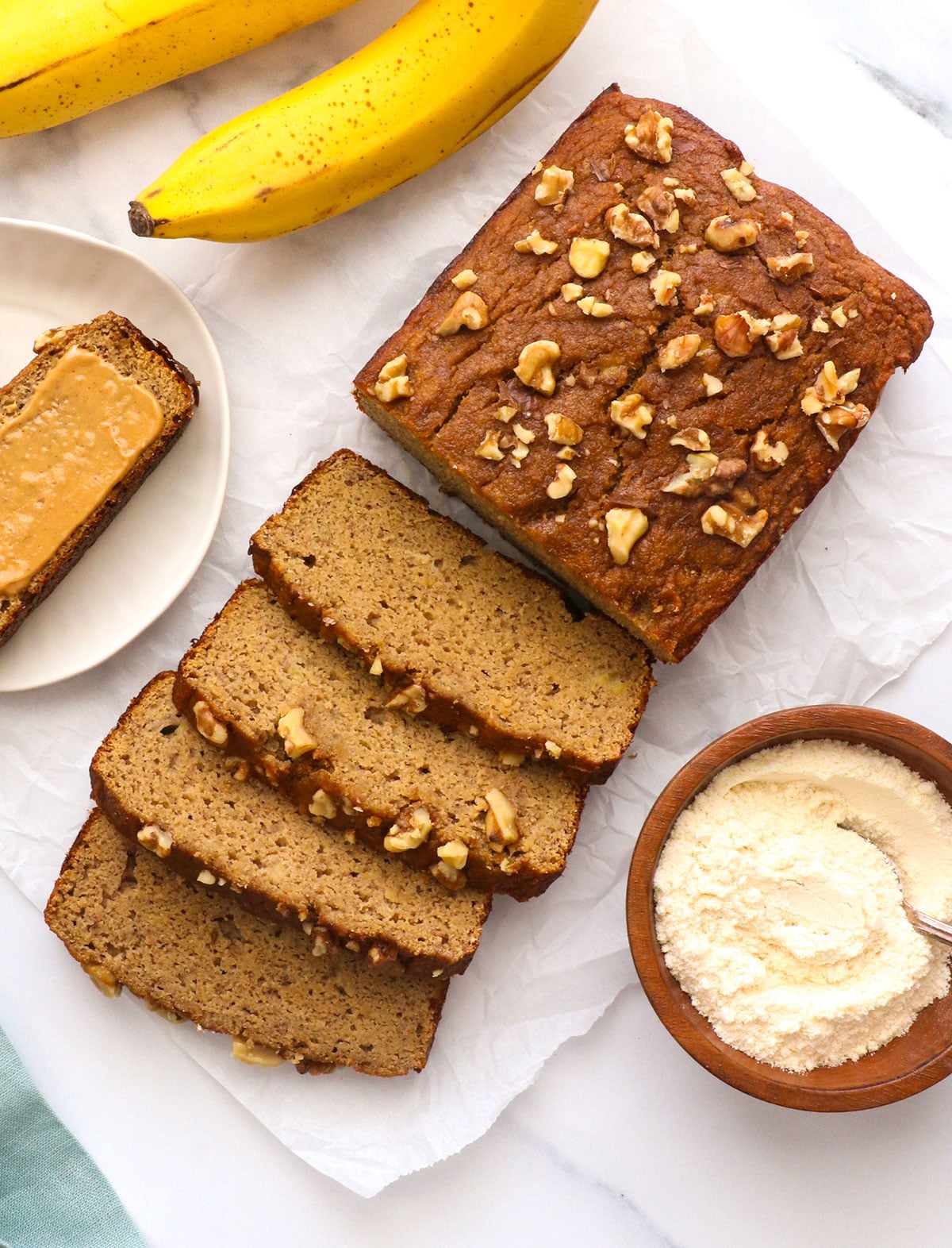 coconut flour banana bread with one slice topped with peanut butter.