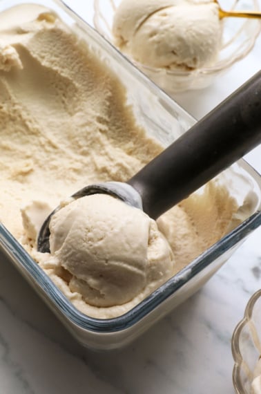 coconut ice cream scooped out of a glass container.