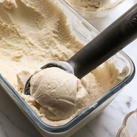coconut ice cream scooped out of a glass container.