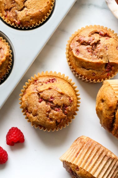 healthy muffin recipe with raspberries on the table.