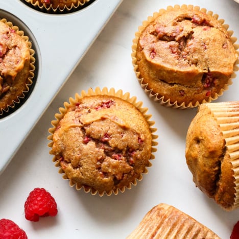 healthy muffin recipe with raspberries on the table.