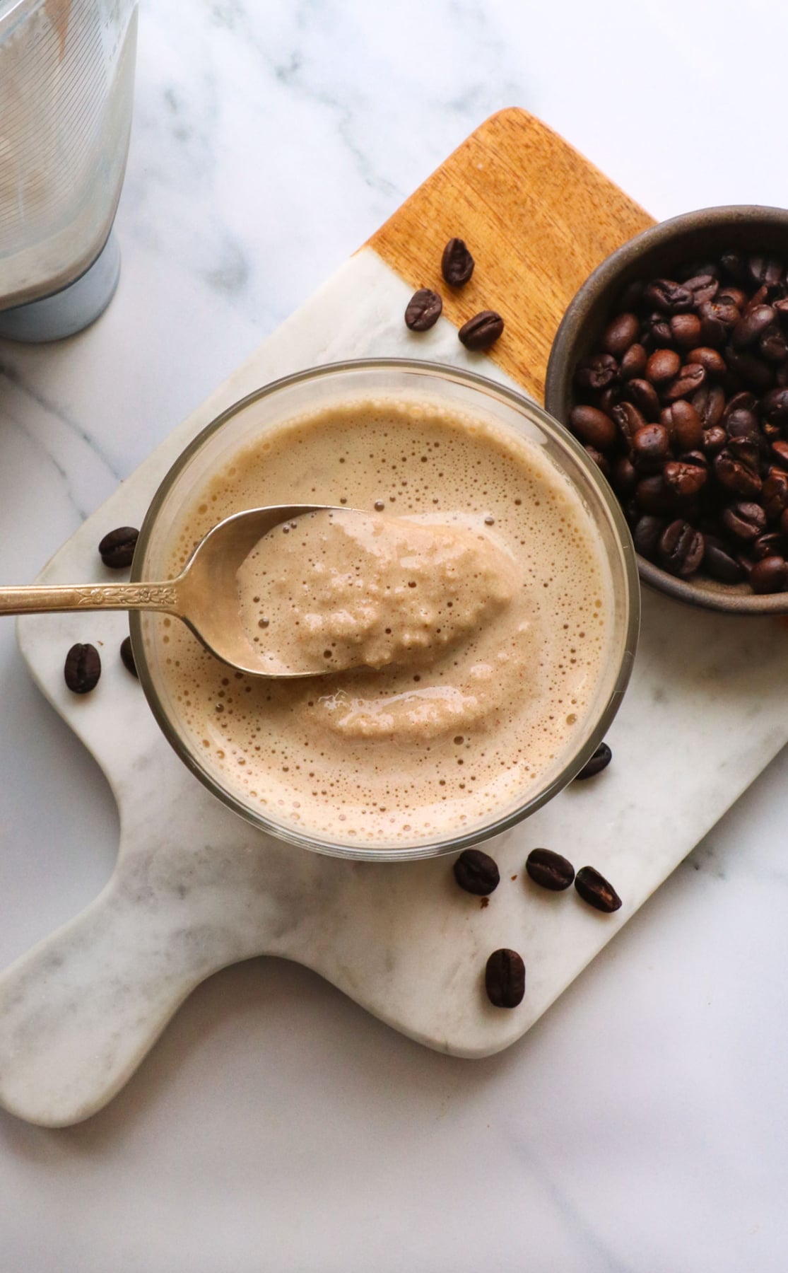 coffee smoothie with a slushy texture lifted on a spoon.