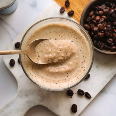 coffee smoothie with a slushy texture lifted on a spoon.