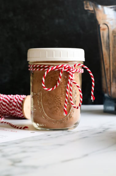 hot chocolate mix jar tied with ribbon for a gift.