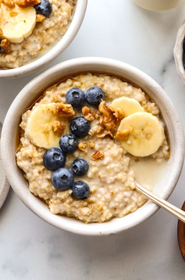 instant pot steel cut oats with berries and banana on top.