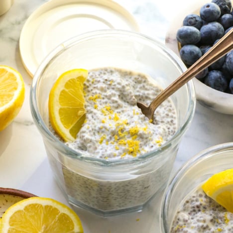 lemon chia pudding topped with a lemon slice and zest.