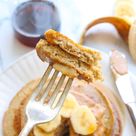 banana oatmeal pancakes lifted up as a bite on a fork.