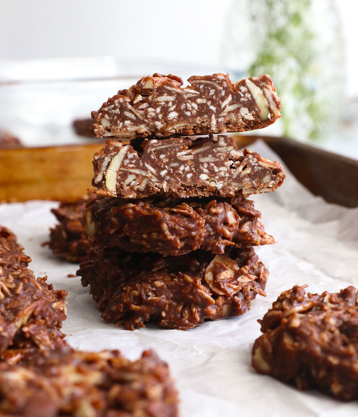 paleo no bake cookies stacked on a pan.