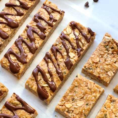 homemade granola bars sliced and topped with melted chocolate.