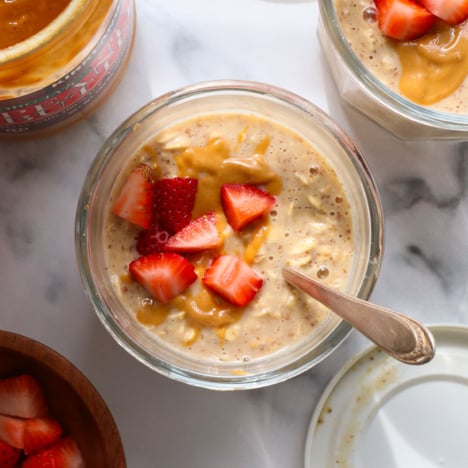 pb overnight oats topped with chopped strawberries.
