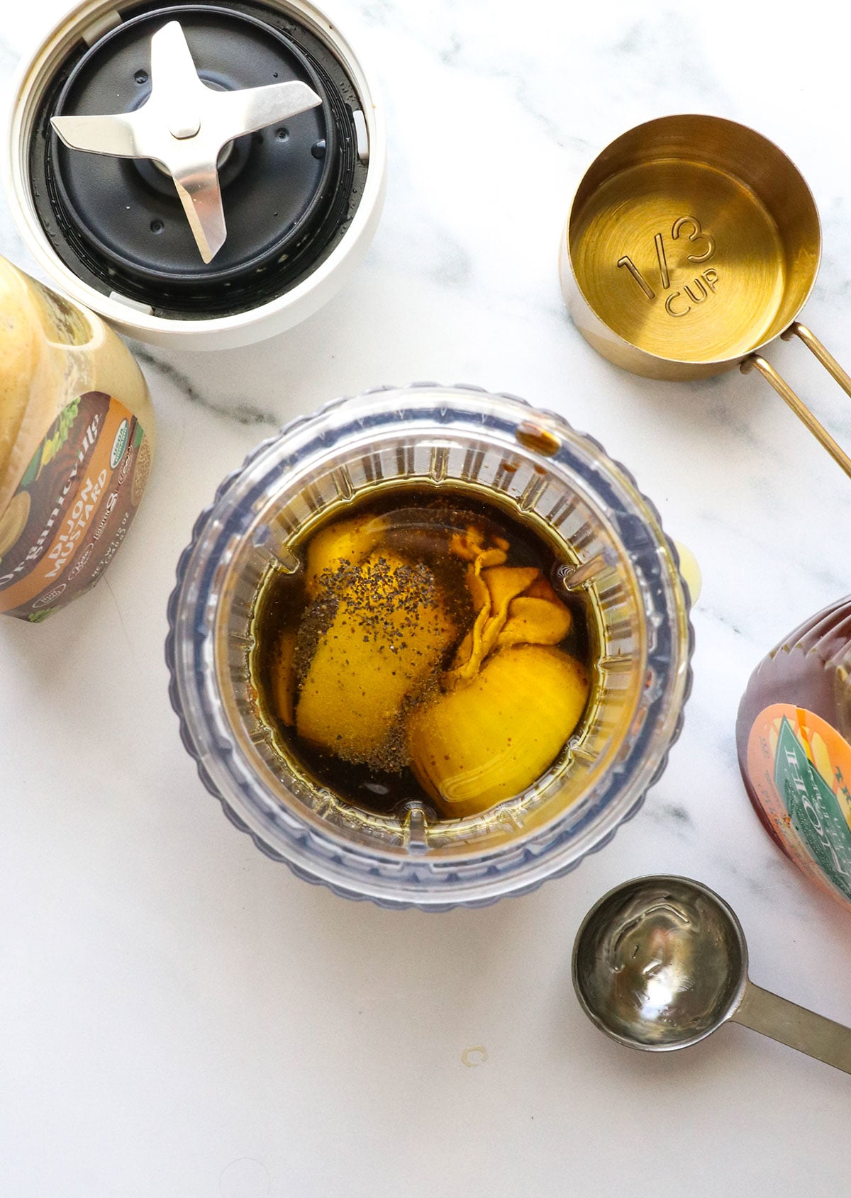shallot, mustard, oil, and vinegar added to a small blender.