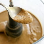 sunflower seed butter lifted up on a spoon.