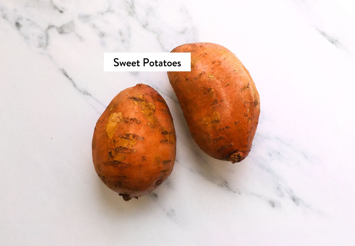sweet potatoes labeled on a white surface.