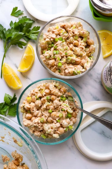 two jars of tuna and chickpea salad with lids.