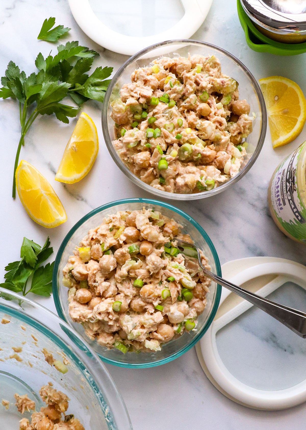 two jars of tuna and chickpea salad with lids.