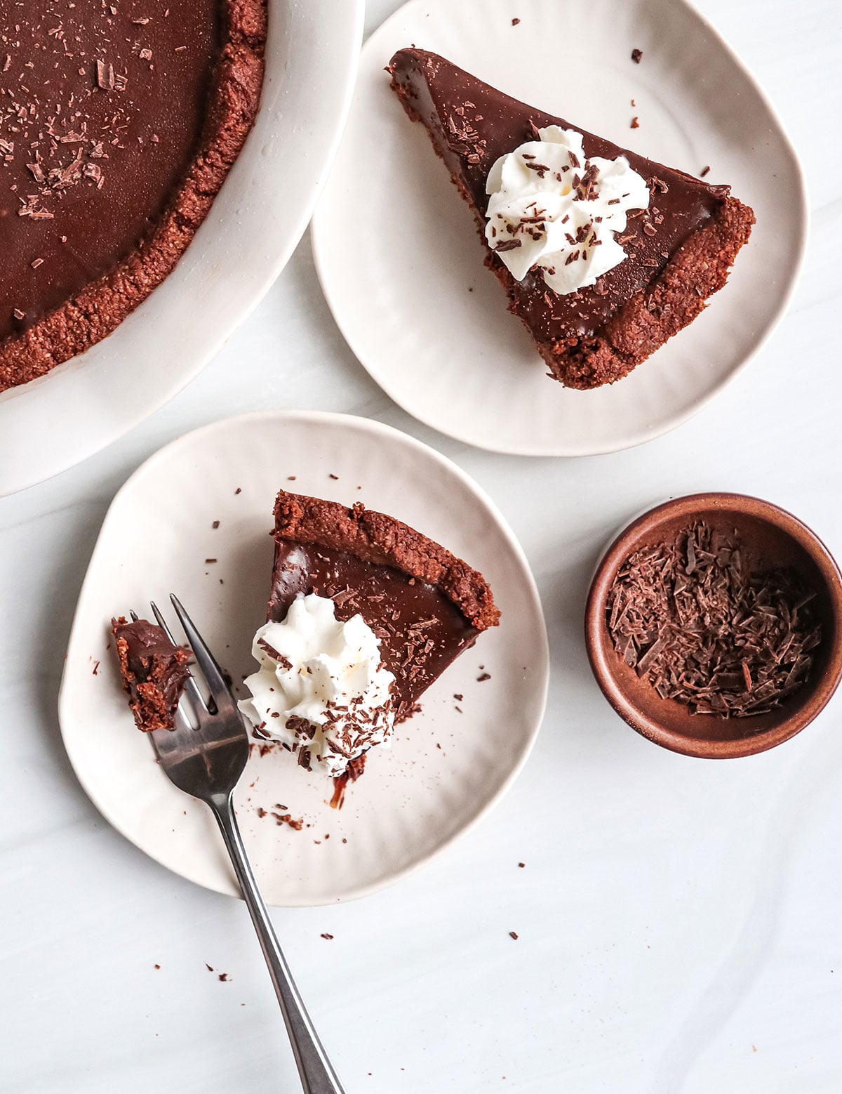 chocolate pie slices on two white plates.