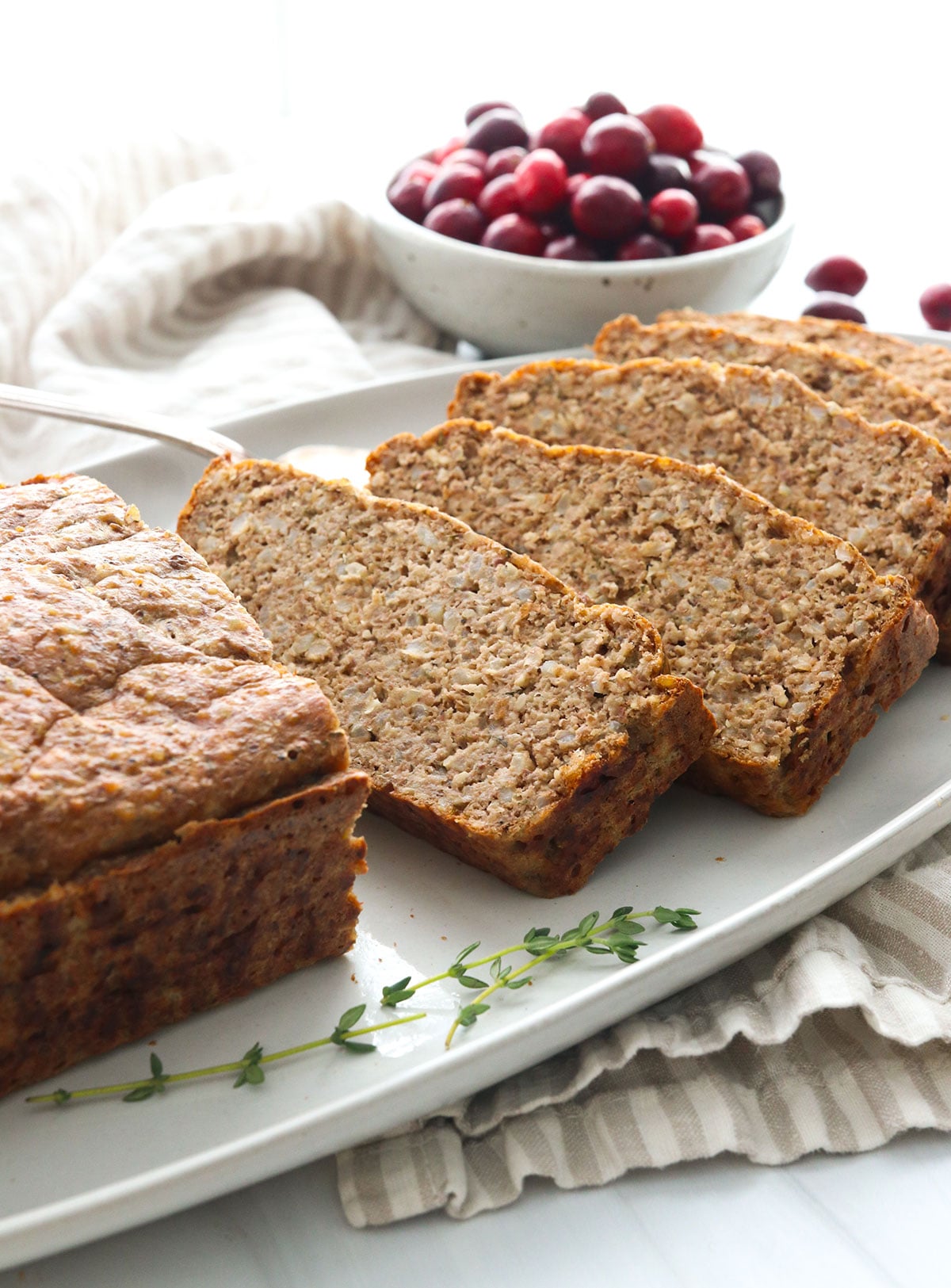 Vegetarian meatloaf sliced on a serving plate.