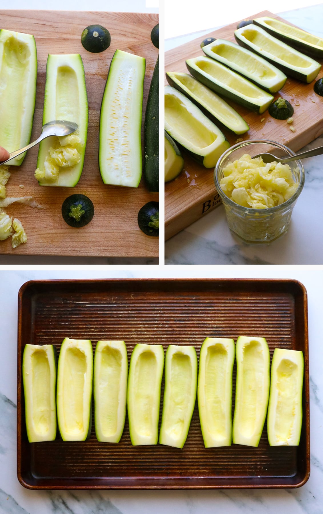 zucchini sliced in half and scooped out on a baking sheet. 